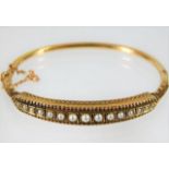 A c.1900 15ct gold bangle set with pearl 10.7g