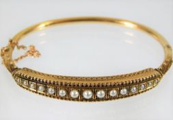 A c.1900 15ct gold bangle set with pearl 10.7g