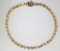 A 14ct gold tennis bracelet set with 4ct diamonds