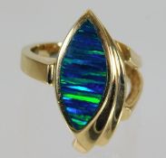 A 14ct gold ring with opalescent style stone 8.6g