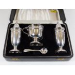 A cased Viners silver three piece cruet set with s