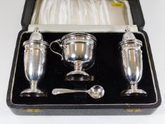 A cased Viners silver three piece cruet set with s