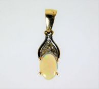 A 9ct mounted opal pendant with three small diamon