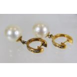 A pair of 18ct gold pair of diamond & 13mm pearl e