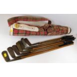 A Spalding golf club case twinned with seven hickory clubs including a Ben Sayers putter