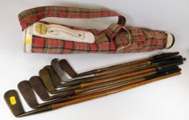 A Spalding golf club case twinned with seven hickory clubs including a Ben Sayers putter