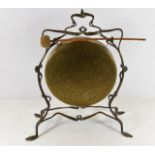 A brass dinner gong set within organic framework