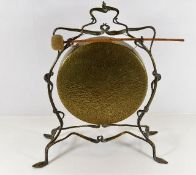 A brass dinner gong set within organic framework