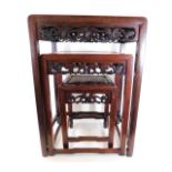 A nest of three Chinese hardwood tables with carve