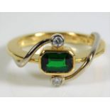 An 18ct gold ring set with green garnet & diamonds