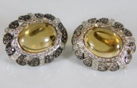 A pair of 18ct white gold earrings set with diamon
