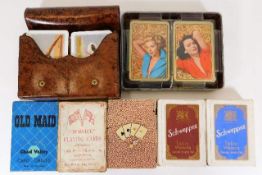 A quantity of vintage playing cards including Schw