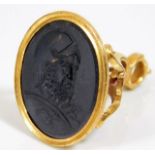 An 18thC. yellow metal seal, tests as high carat gold, with crest in basalt