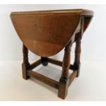A small early 20thC. oak drop leaf table