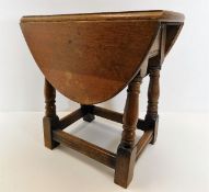 A small early 20thC. oak drop leaf table