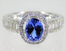 An 18ct white gold tanzanite & diamond cluster rin