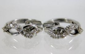 A pair of 14ct white gold earrings with approx. 0.