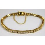 An 18ct gold tennis bracelet set with approx. 6ct