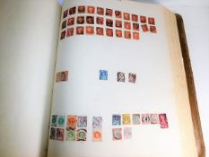 A large stamp album 17.5in x 14.75in x 3in of many