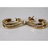 A pair of 9ct gold diamond earrings set with appro