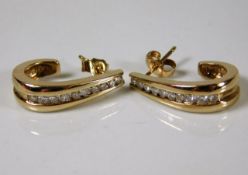 A pair of 9ct gold diamond earrings set with appro