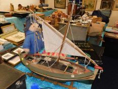 A wooden model boat with stand