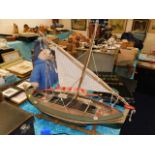 A wooden model boat with stand