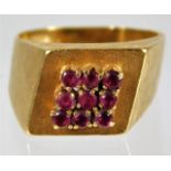 An 18ct gold ring set with nine rubies size L/M 6.