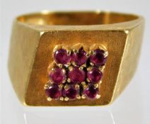 An 18ct gold ring set with nine rubies size L/M 6.