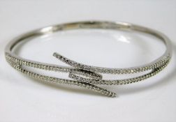 An 18ct white gold bangle set with diamonds 12.7g