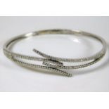 An 18ct white gold bangle set with diamonds 12.7g