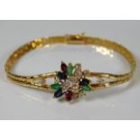 An 18ct gold diamond, ruby, sapphire & emerald bra