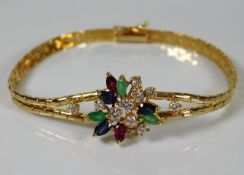 An 18ct gold diamond, ruby, sapphire & emerald bra