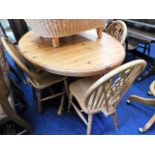 A pine dining table with four chairs