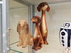 Two Jema dog figures twinned with a Sylvac dog