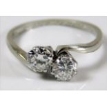 An 18ct white gold crossover ring set with 1ct of