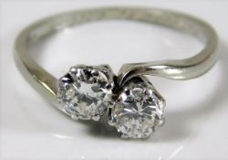 An 18ct white gold crossover ring set with 1ct of