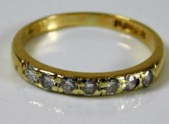 An 18ct gold seven diamond ring size M/N 2.1g