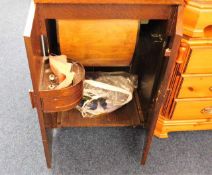 An oak electric sewing machine with cabinet