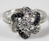 A 14ct white gold ring set with black & white diam