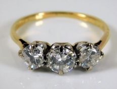 An 18ct gold diamond trilogy ring of 1.2ct size M/