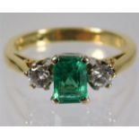 An 18ct gold diamond & emerald ring set with 0.4ct