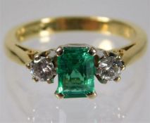 An 18ct gold diamond & emerald ring set with 0.4ct