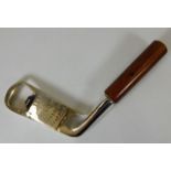 A silver plated golf club bottle opener