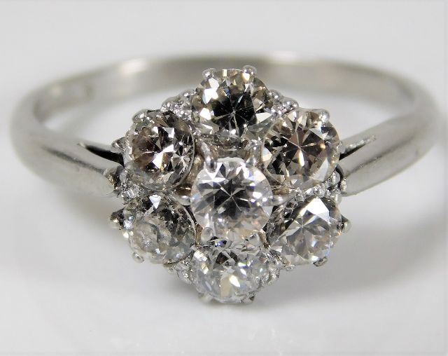 A platinum daisy style ring set with approx. 1.45c