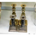 A pair of silver plated candlesticks twinned with