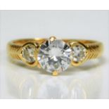 An 18ct gold ring set with 1.4ct diamonds, the cen