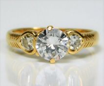 An 18ct gold ring set with 1.4ct diamonds, the cen