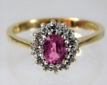 A 9ct gold ring set with pink sapphire & diamond s