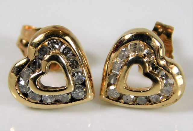 A pair of 9ct gold heart shaped earrings set with